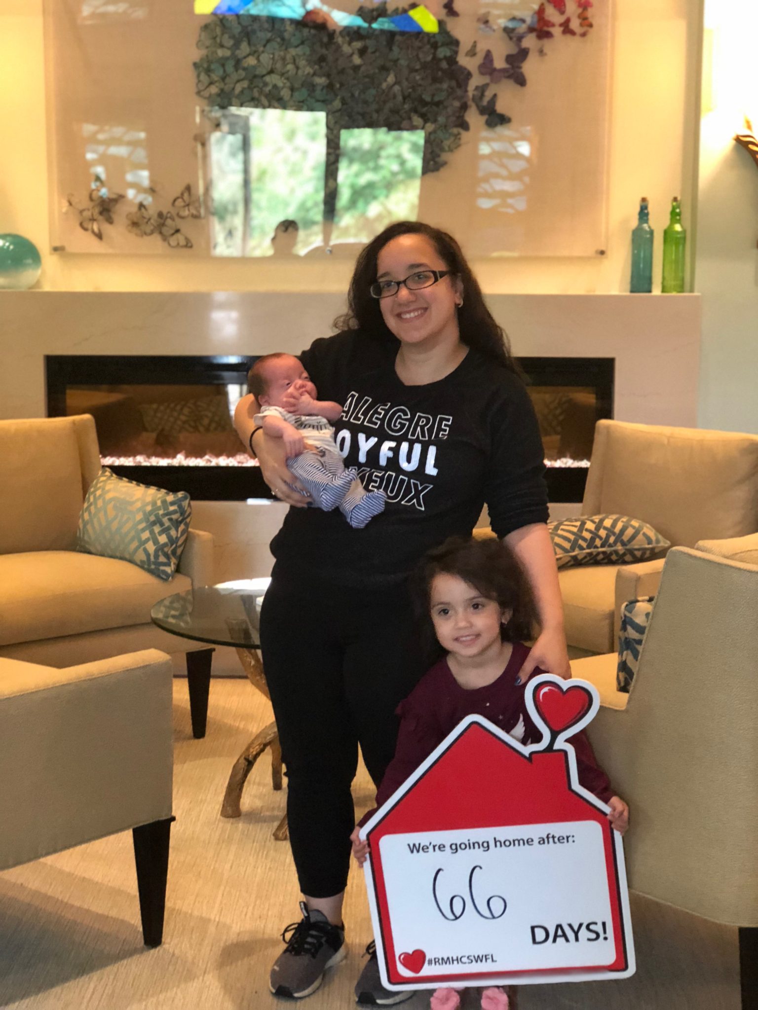 Mother holding her baby with her young daughter at Ronald McDonald House